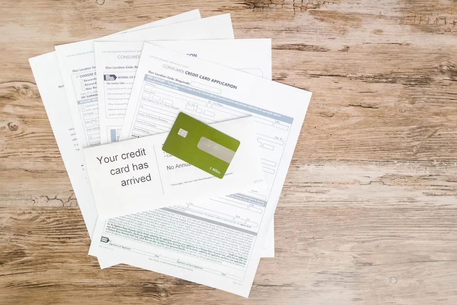 A payment card resting on a stack of paperwork